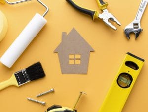 cardboard house with tools flat lay